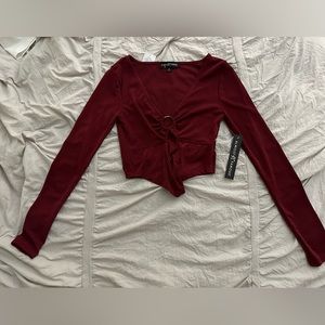 Burgundy cropped long sleeve top.